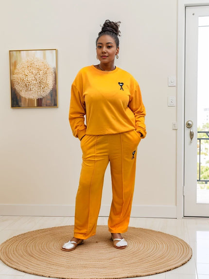 Orange-red loose-fit jogger set with matching sweatshirt, embroidered cat logo detail