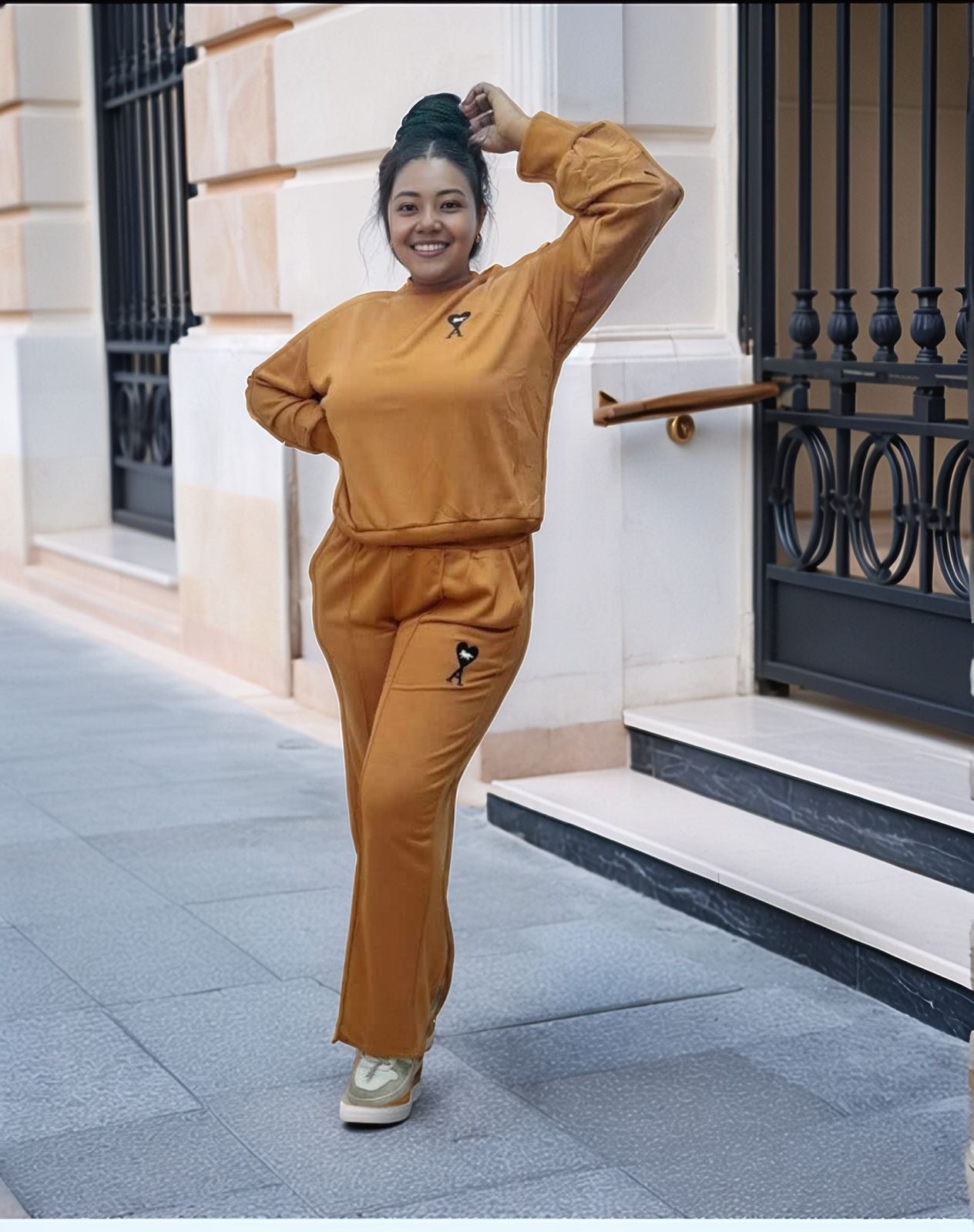 Tan two-piece jogger set with crew sweatshirt and tapered pants, small chest emblem