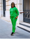 Green two-piece jogger set with crew sweatshirt and tapered pants, small chest emblem