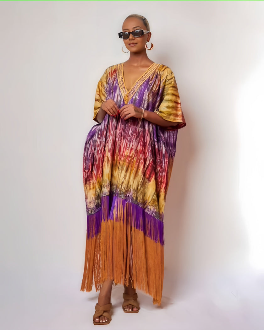 Abstract print kaftan dress with V-neck, half sleeves, and fringe hem in warm tones