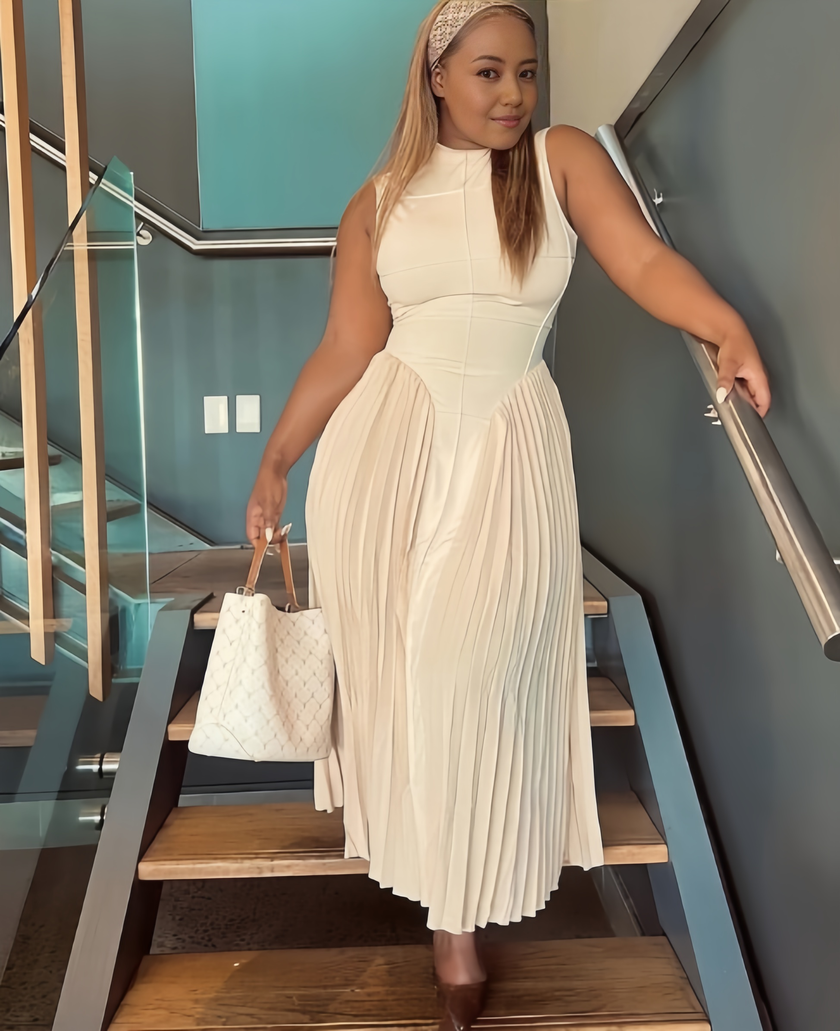 Beige A-line midi dress with defined waist paneling and pleated skirt, sleeveless