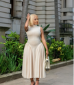 Beige A-line midi dress with defined waist, sleeveless high neck, pleated midi skirt