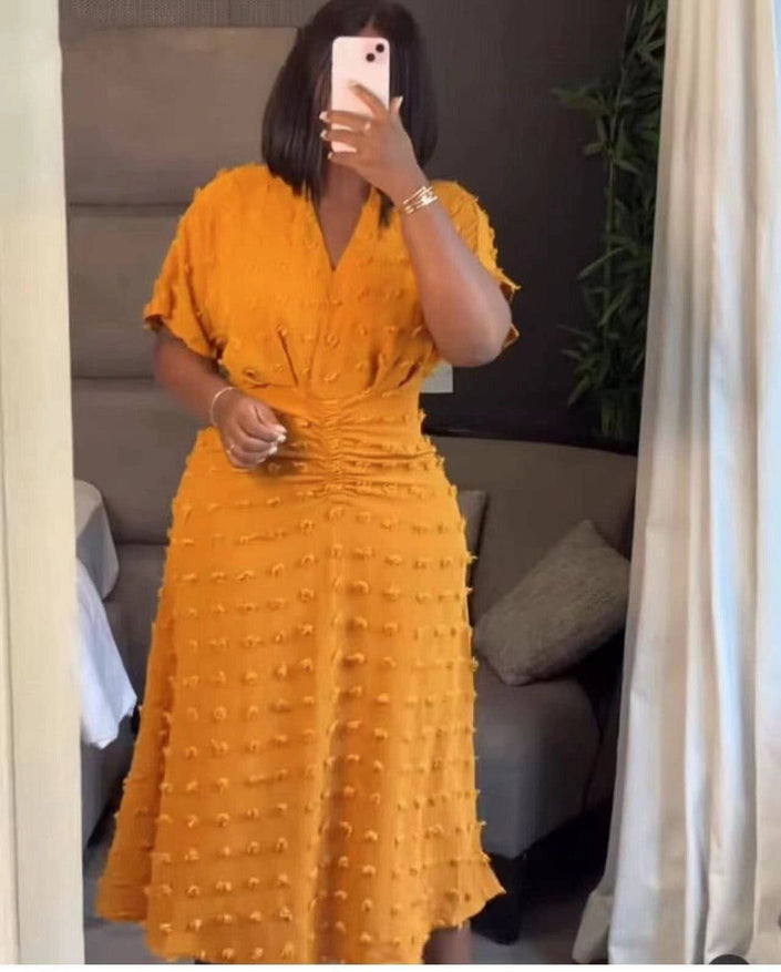 Yellow textured dot midi dress with cinched waist, V-neck, short sleeves