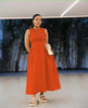 Orange-red sleeveless maxi dress with pleated waist, round neckline and A-line hem