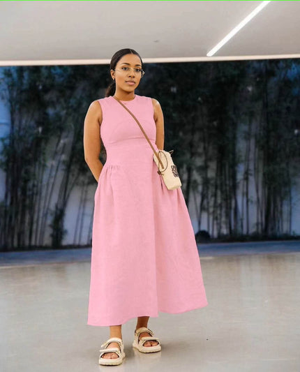 Pink sleeveless maxi dress with pleated waist, round neckline and A-line skirt