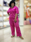 Deep-pink V-neck button-front loose jumpsuit with short sleeves and side pockets