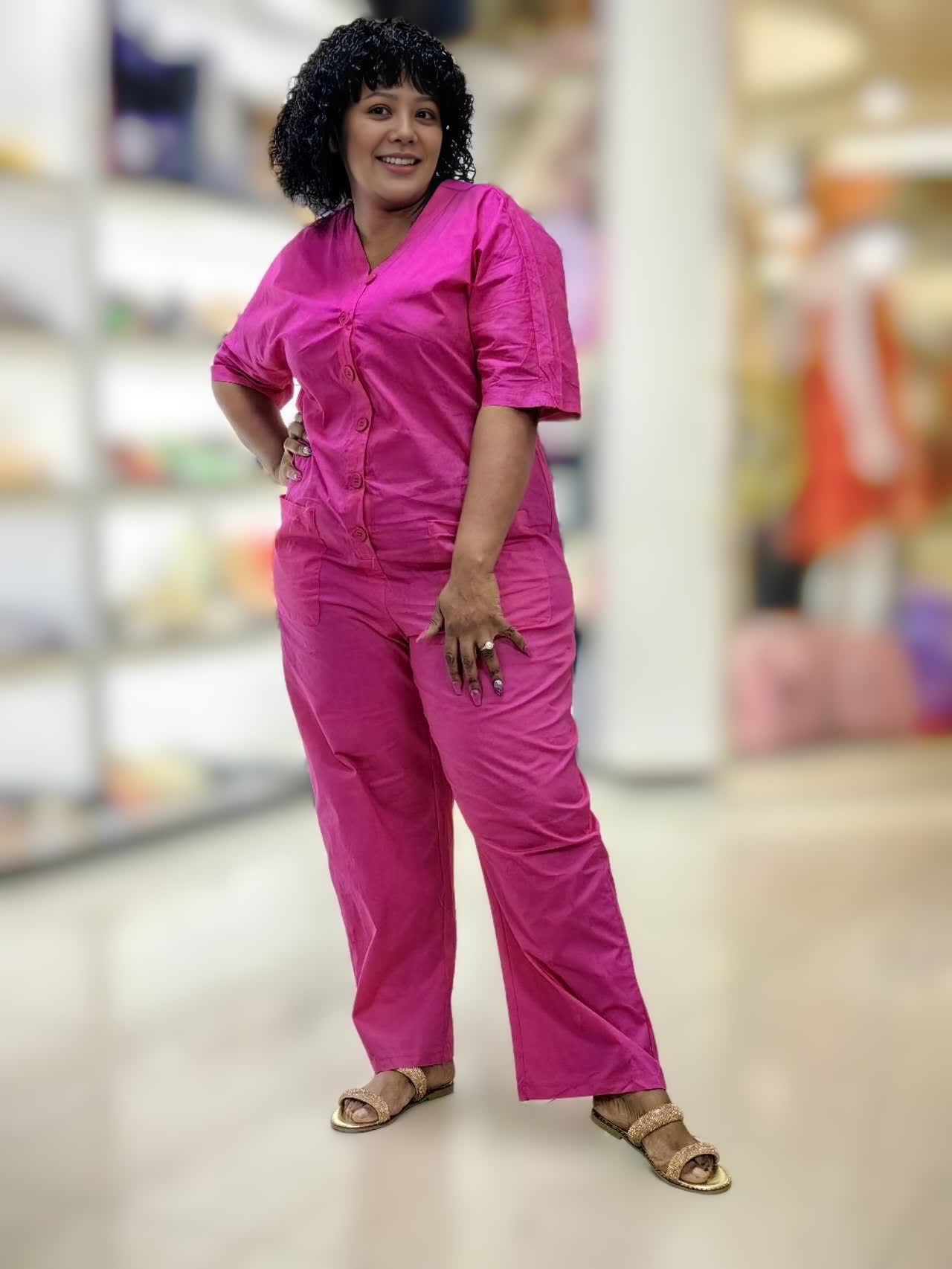 Deep-pink V-neck button-front loose jumpsuit with short sleeves and side pockets
