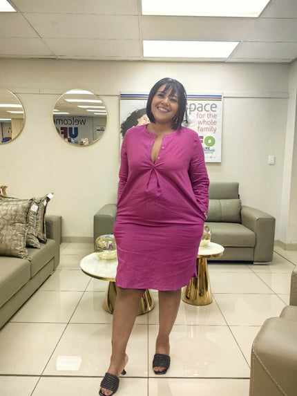 Magenta shirt dress with long sleeves, V-neck and button front, fitted knee length
