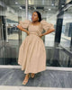 Tan midi dress with puff sleeves, gathered skirt and floral waist accent