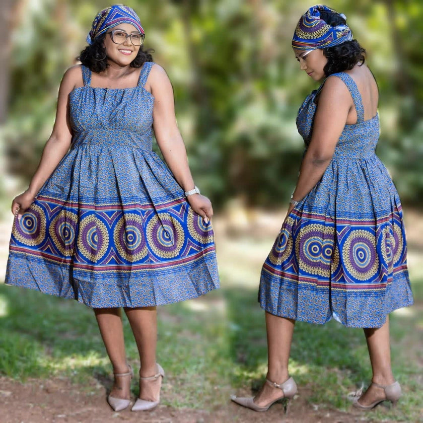 Blue sleeveless midi dress with African print, gathered skirt and round neckline