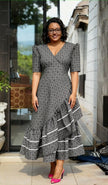 Gray patterned high-low ruffle dress with puff sleeves, V-neck, and tiered hem trim