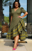 Green patterned high-low ruffle dress with puff sleeves, V-neck, and yellow tiered trim