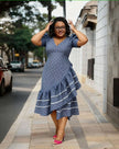 Blue patterned high-low ruffle dress with puff sleeves, V-neck, and white tiered trim