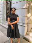 Black midi dress with short sleeves, collar, belted waist tie, pleated midi skirt