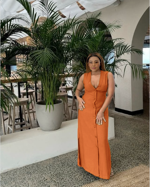 Orange sleeveless V-neck midi dress with button-down front and fitted waist