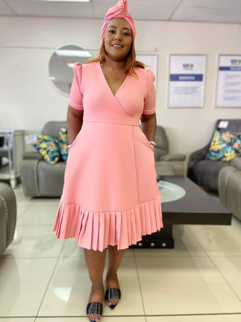 Plus size wrap midi dress in dusty pink with short sleeves and pleated ruffle hem