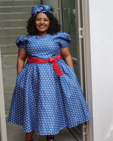 Blue polka dot puff-sleeve dress with gathered skirt and red waist bow