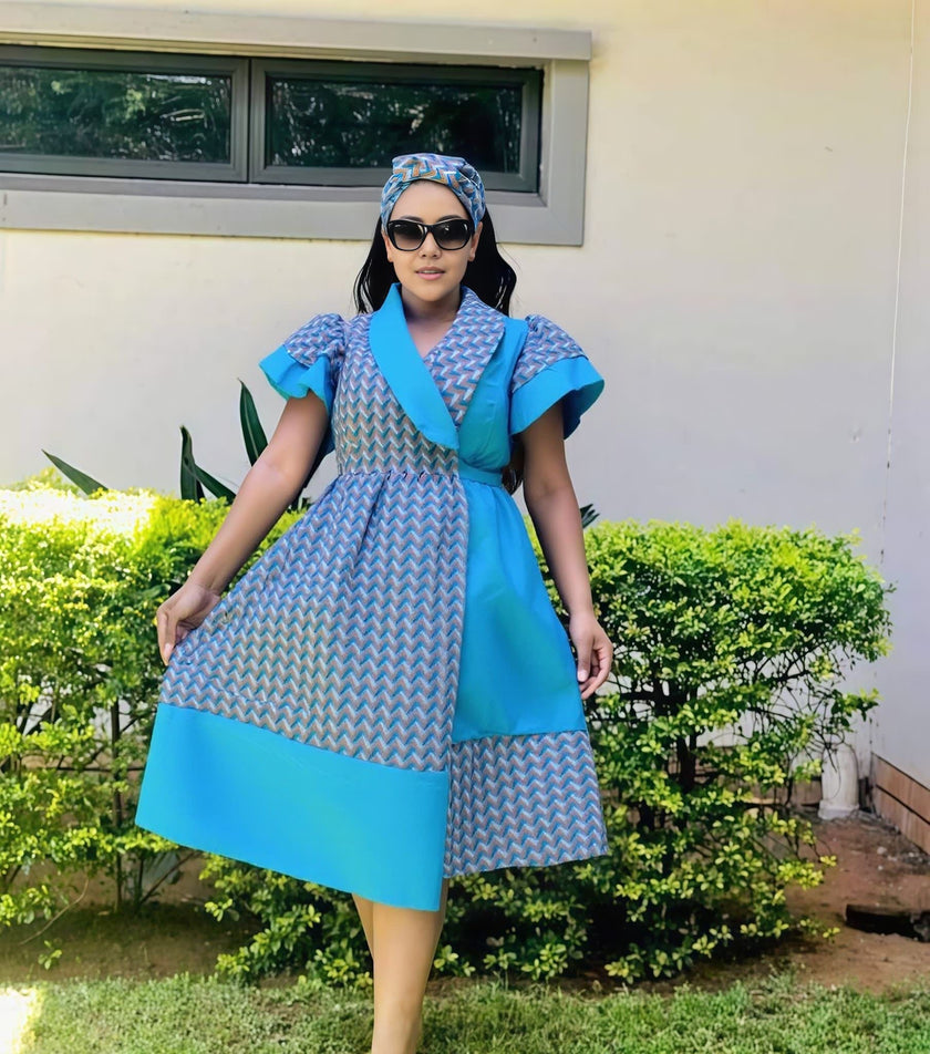 Blue geometric print puff sleeve dress with V-neck and tie belt, knee length