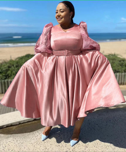 Plus size midi dress with puff sleeves, belted waist, flared skirt in soft pink