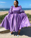 Plus size midi dress with puff sleeves, belted waist, flared skirt in lavender purple