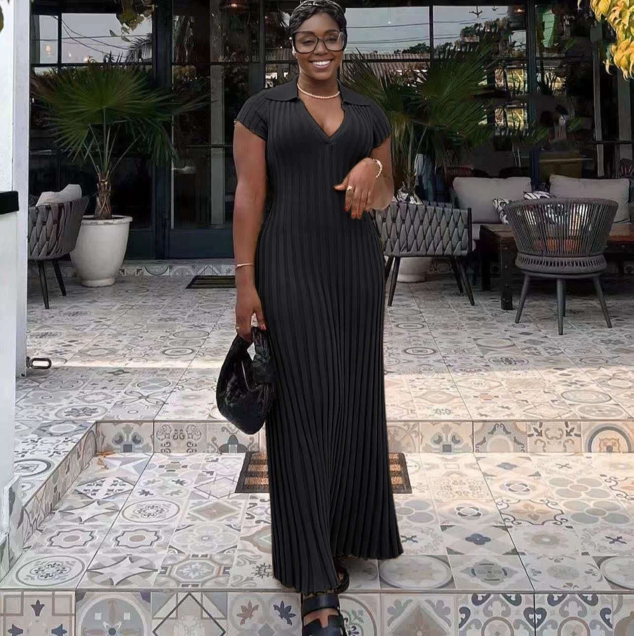 Black ribbed knit maxi dress with V-neck, short sleeves, pleated column look