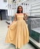 Beige sleeveless square-neck maxi dress with pleated skirt and tied shoulder straps