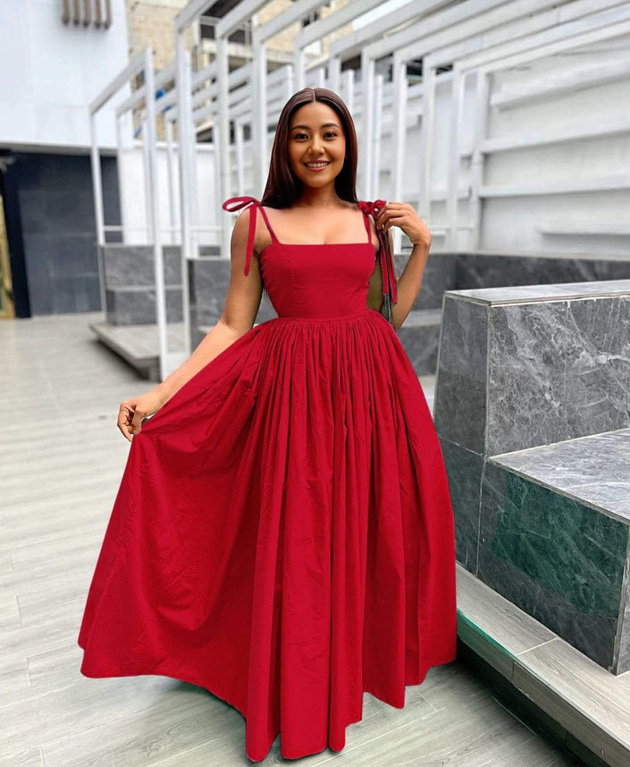 Red sleeveless square-neck maxi dress with pleated skirt and tied shoulder straps