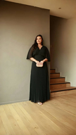 Black pleated maxi dress with V-neck and batwing sleeves, full-length skirt
