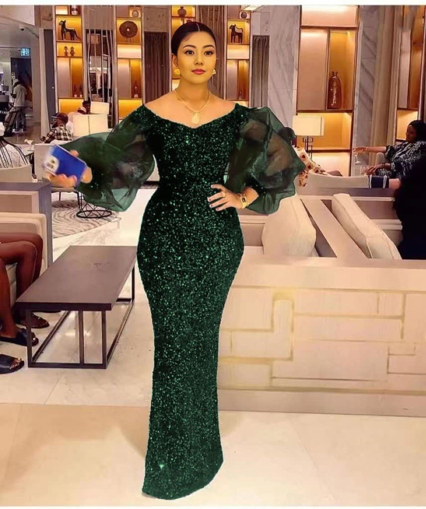 Dark green sequin maxi dress with sheer puff sleeves and fitted column silhouette