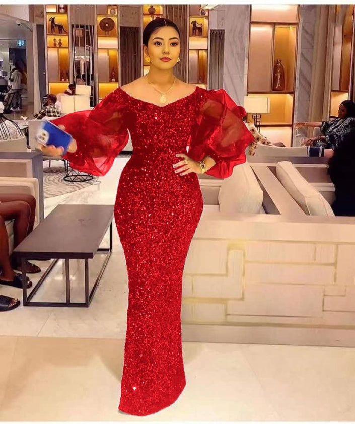 Red sequin maxi dress with sheer puff sleeves and fitted column silhouette