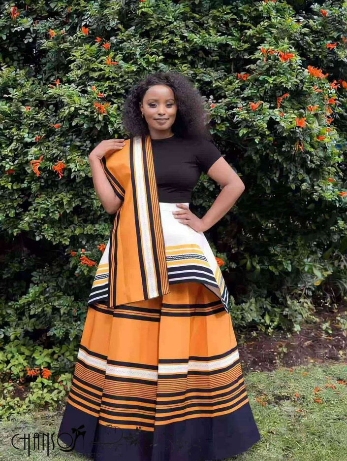 African maxi skirt set with black top and orange striped tiered skirt