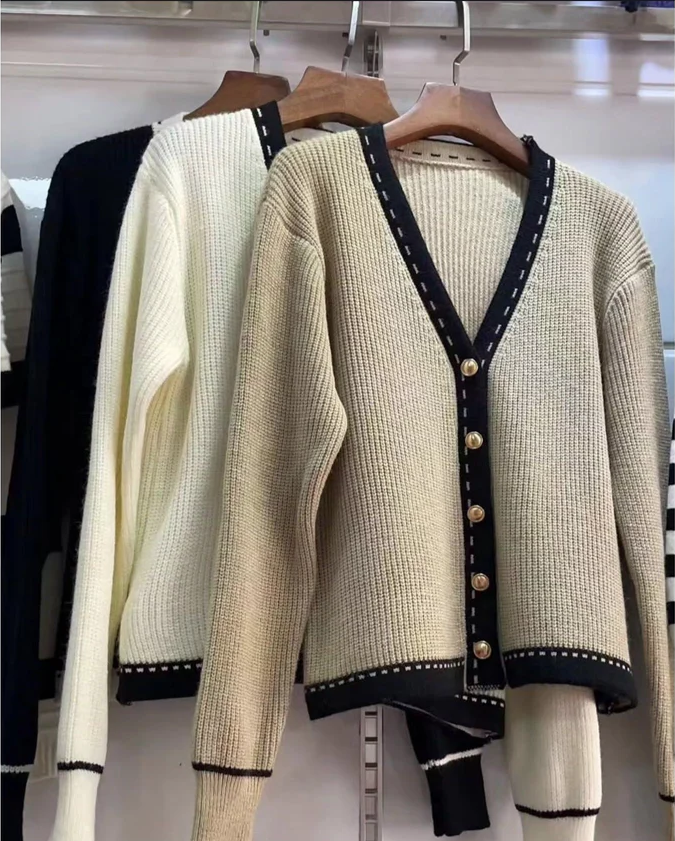 Beige knit V-neck cardigan with black trim and button front