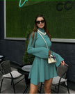 Mint-green ribbed knit dress with high neck, long sleeves, flared loose skirt