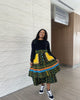 Layered three-piece skirt set with dark top and green patterned tiered skirt with yellow trim