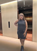 Elegant Sleeveless Mini Dress with Button Accents and Waist Pocket Design