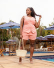 Pink sleeveless top and shorts set with button front and scalloped hem