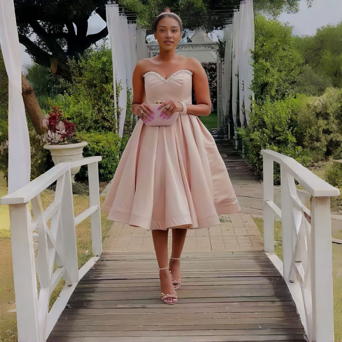 Pink strapless midi dress with sweetheart neckline and flared waist detail