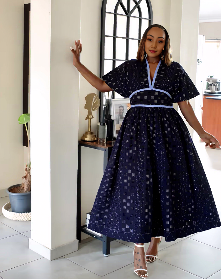 Navy patterned A-line midi dress with puff sleeves and flared skirt, tied belt