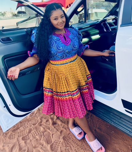 African Traditional Pleated Skirt Set with Circular Motifs and Puff Sleeve Top