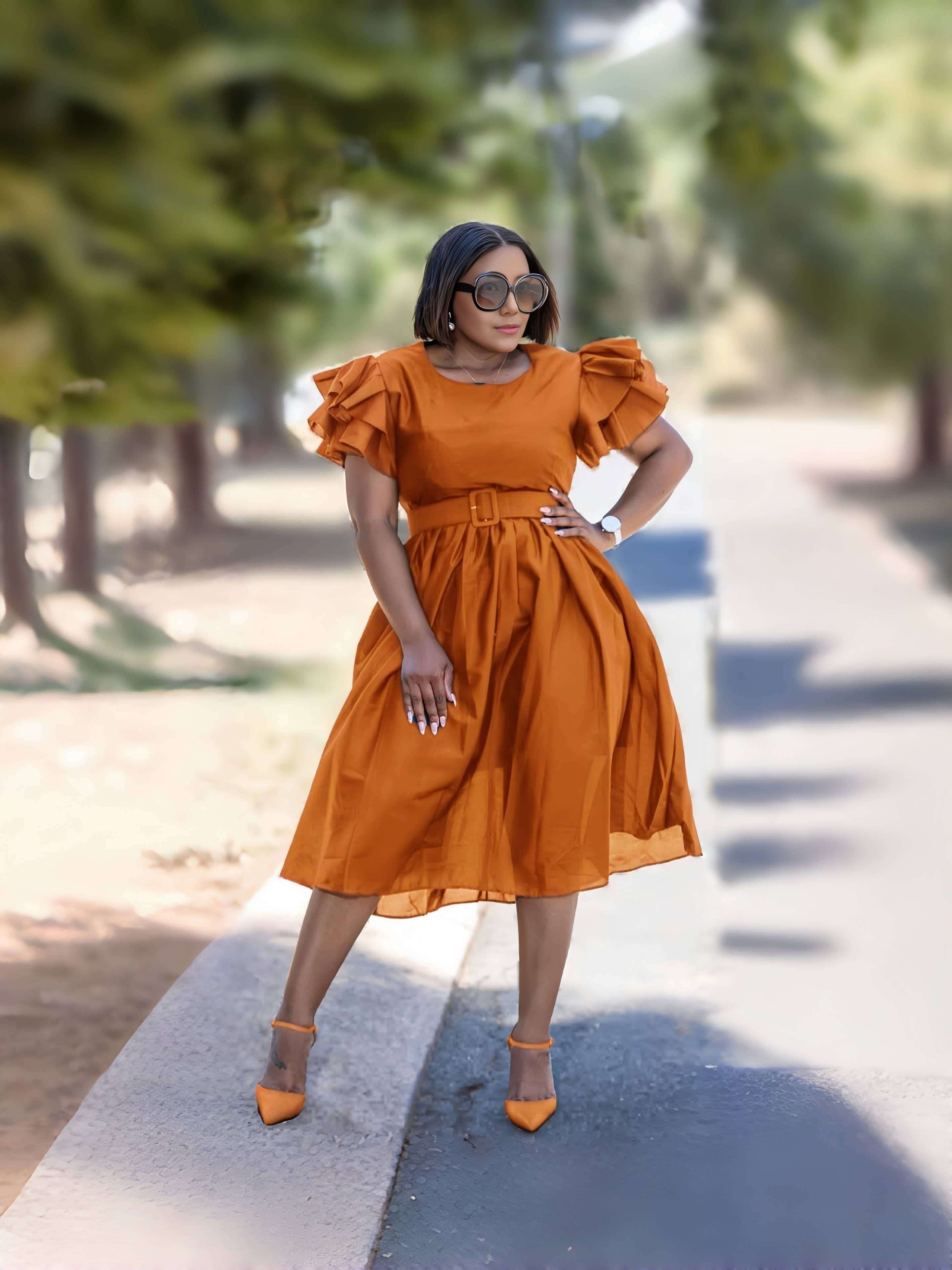 Belted vintage puff sleeve midi dress in rust-orange, short puff sleeves and waist belt