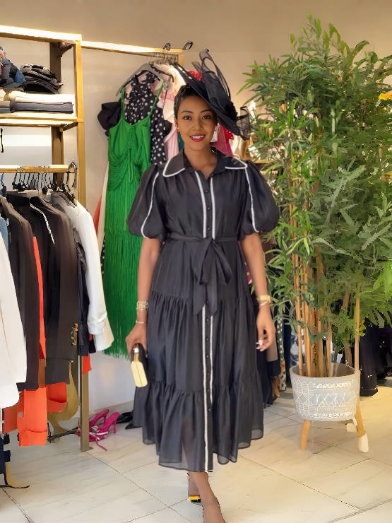 Black puff sleeve tiered dress with white trim, button-front and ruffled skirt