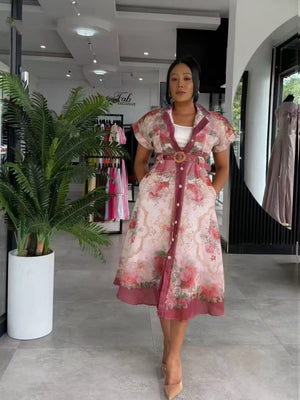 Model wearing belted pink floral midi women's two piece set in a South African fashion retail store