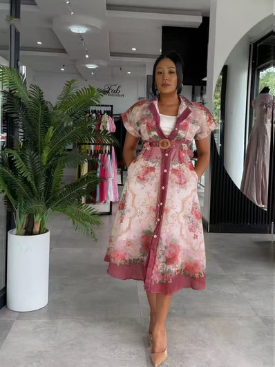 Model wearing belted pink floral midi women's two piece set in a South African fashion retail store