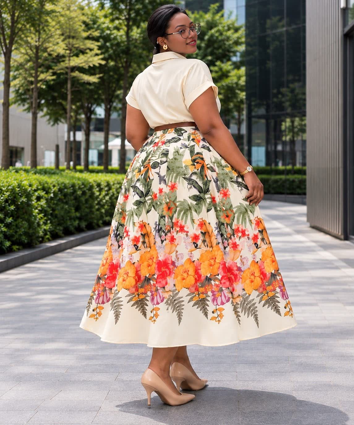 Cream midi shirt dress with short sleeves, a belt, and a full skirt in a colorful floral print.