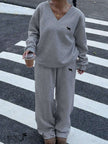 Grey V-neck twin set with small embroidery: sweatshirt top and wide-leg pants.