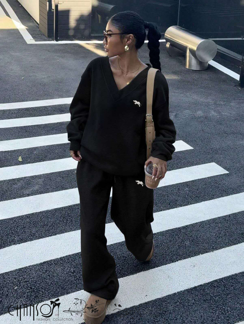 Black V-neck twin set: embroidered sweatshirt top and wide-leg pants.