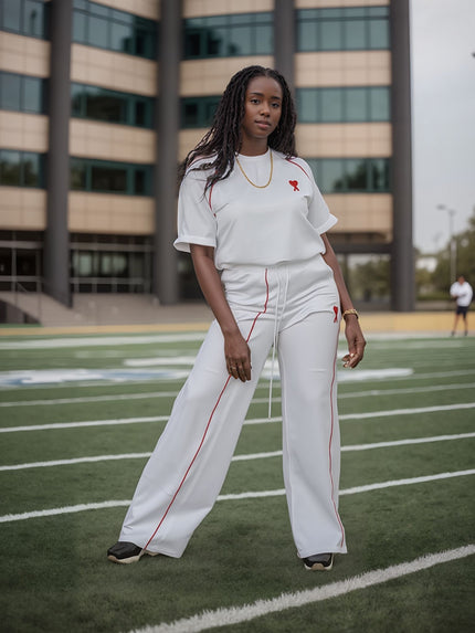 White wide-leg stretch waist pants with red logo accents on side.