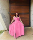 Pink maxi dress with floral cutout waist, sleeveless bodice, pleated full skirt