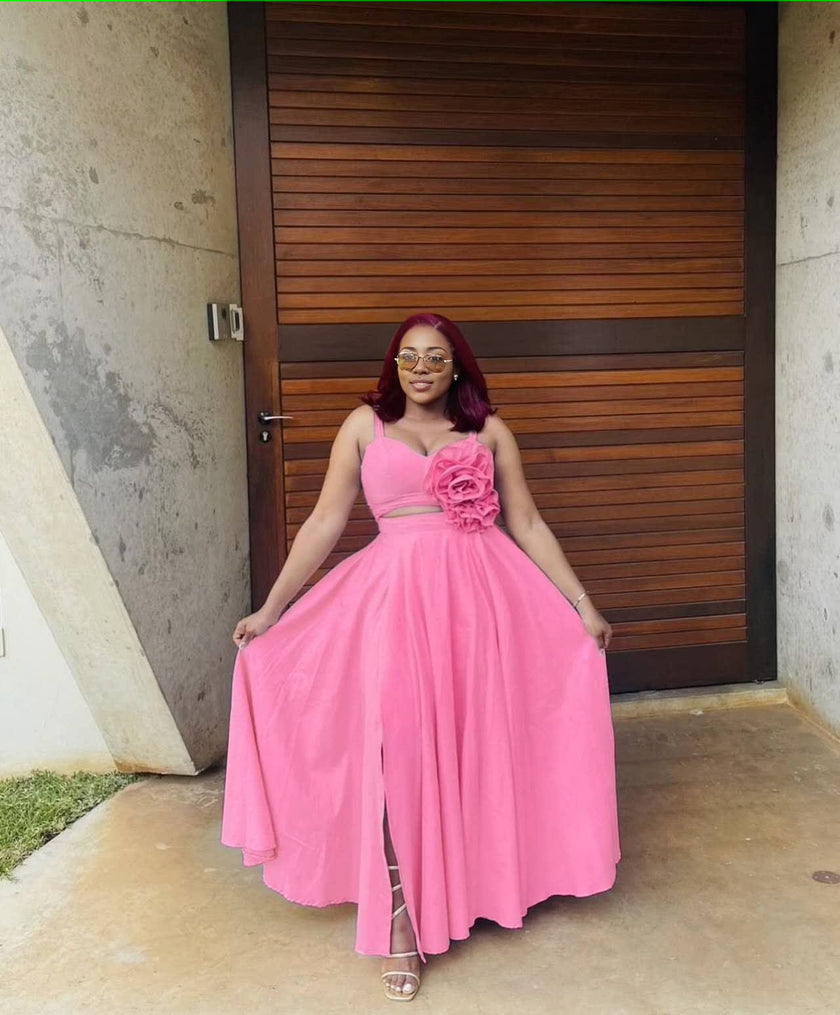 Pink maxi dress with floral cutout waist, sleeveless bodice, pleated full skirt