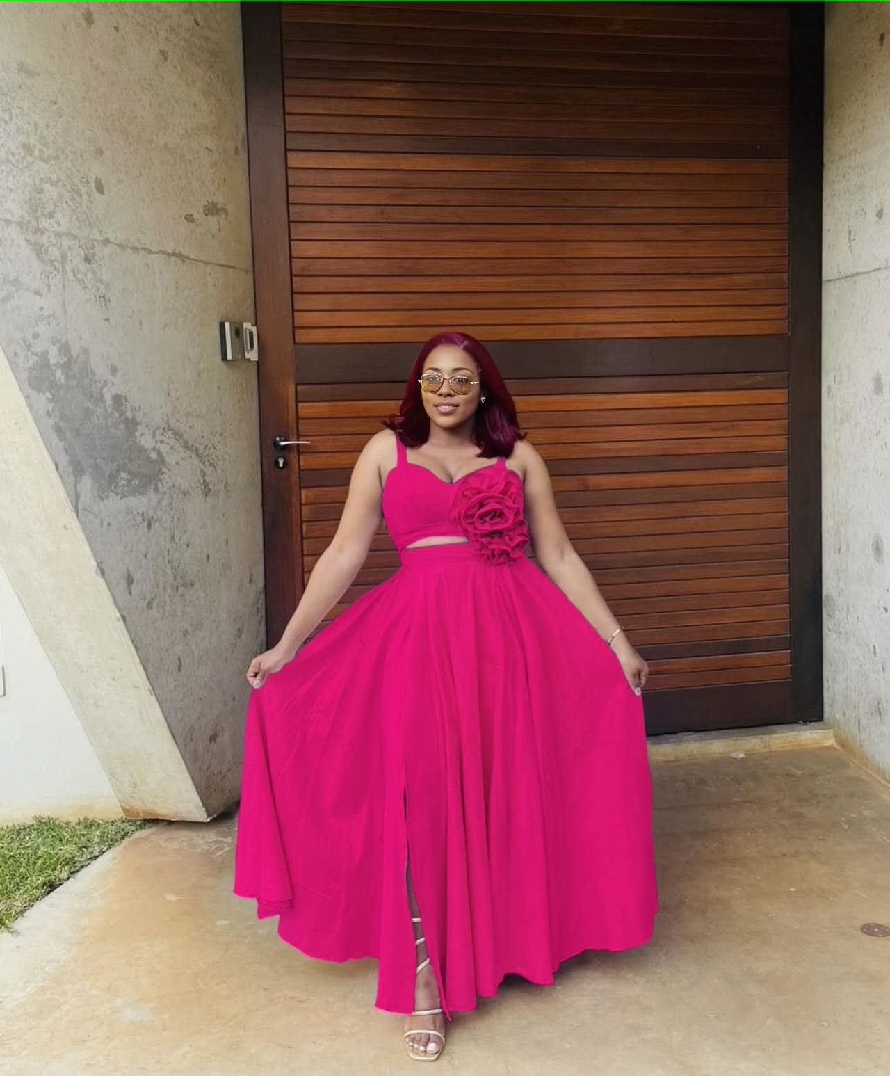 Deep-pink maxi dress with floral cutout waist, sleeveless bodice, pleated full skirt